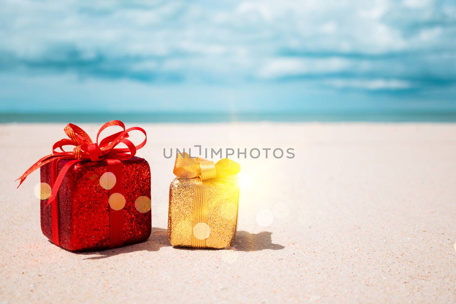 Gift boxes on sandy beach. Hot tours or holiday vacation concept with summer sea. by Suwant