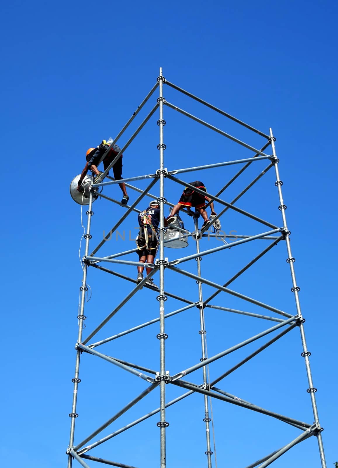 KAOHSIUNG, TAIWAN -- MAY 21, 2017: Workers set up powerful lights on scaffolds in preparation for the upcoming Dragon Boat Festival.