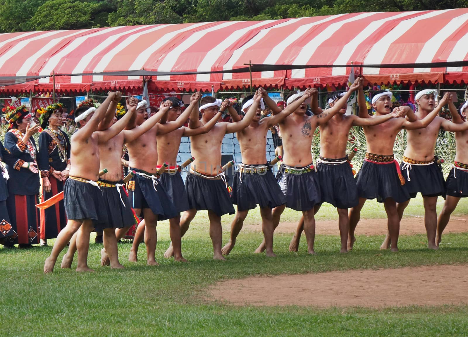 KAOHSIUNG, TAIWAN -- SEPTEMBER 28, 2019: Young men of the indigenous Rukai tribe perform a dance during the traditional harvest festival.