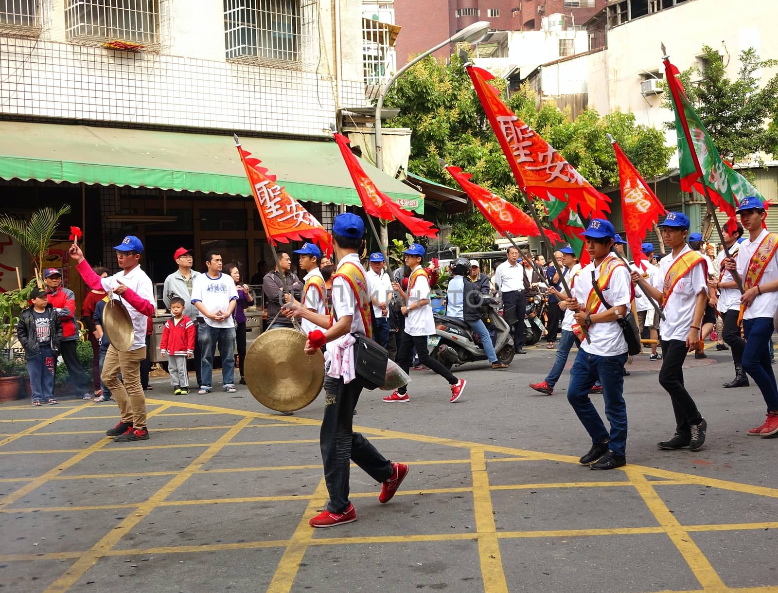 Young Men Carry Flags and Beat Gongs by shiyali