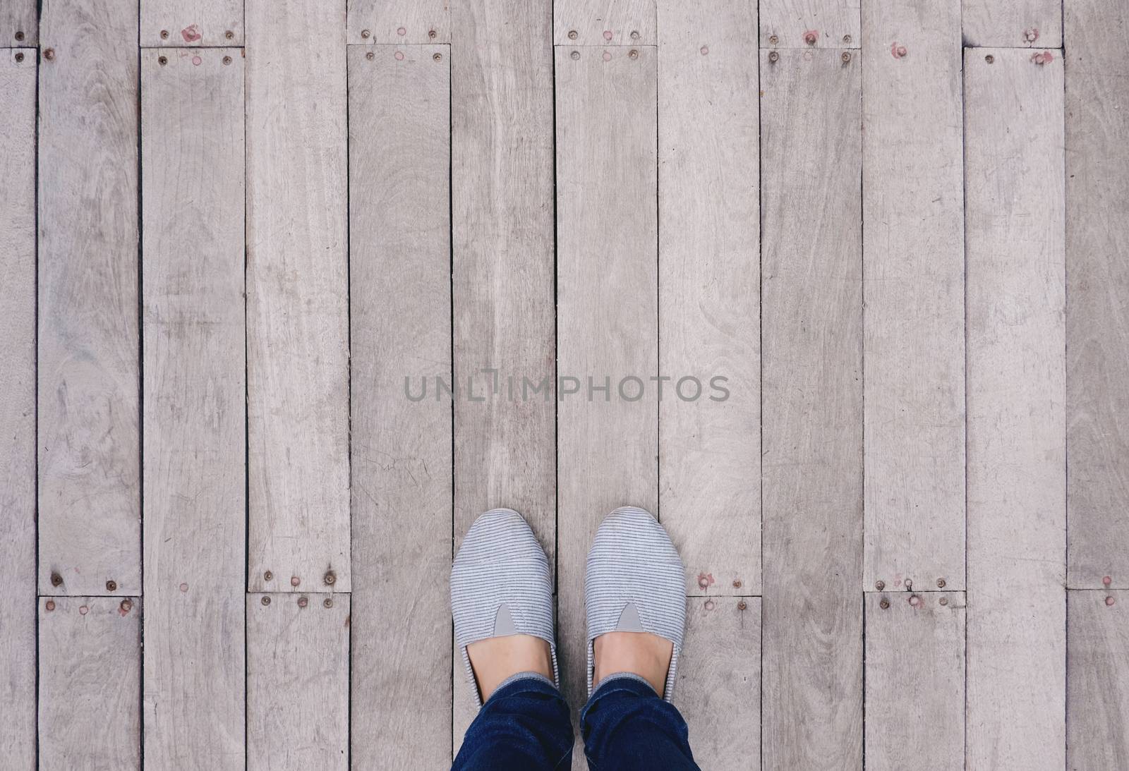 Selfie of feet and shoes on wooden floor background with copy space, top view