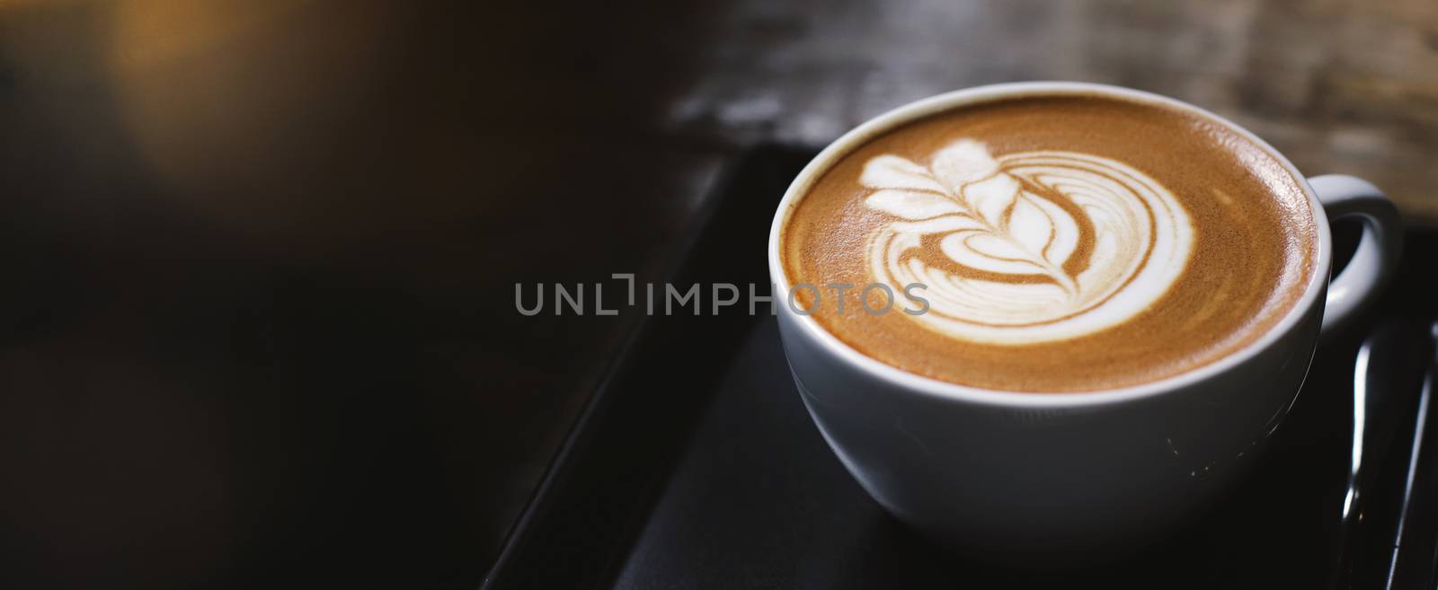 Close up of hot latte coffee in the cafe, photo banner for websi by nuchylee