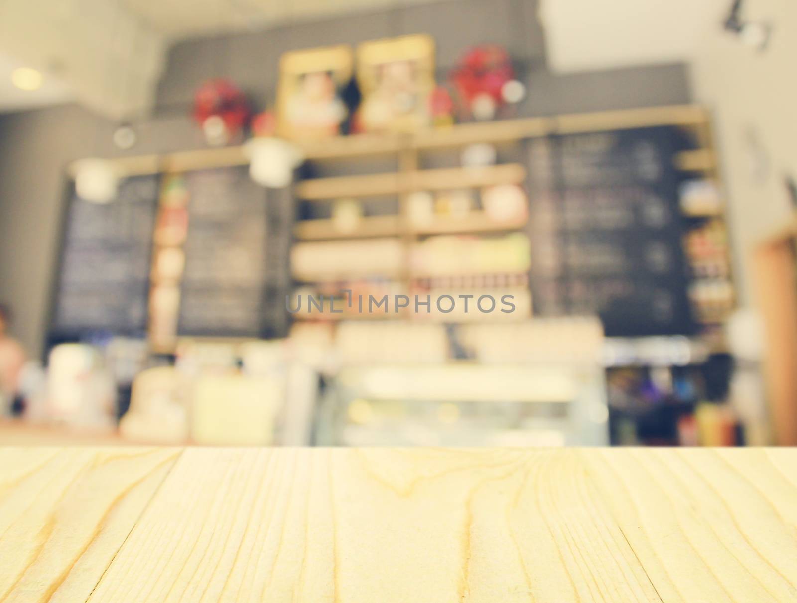 Empty wooden table and blurred cafe background