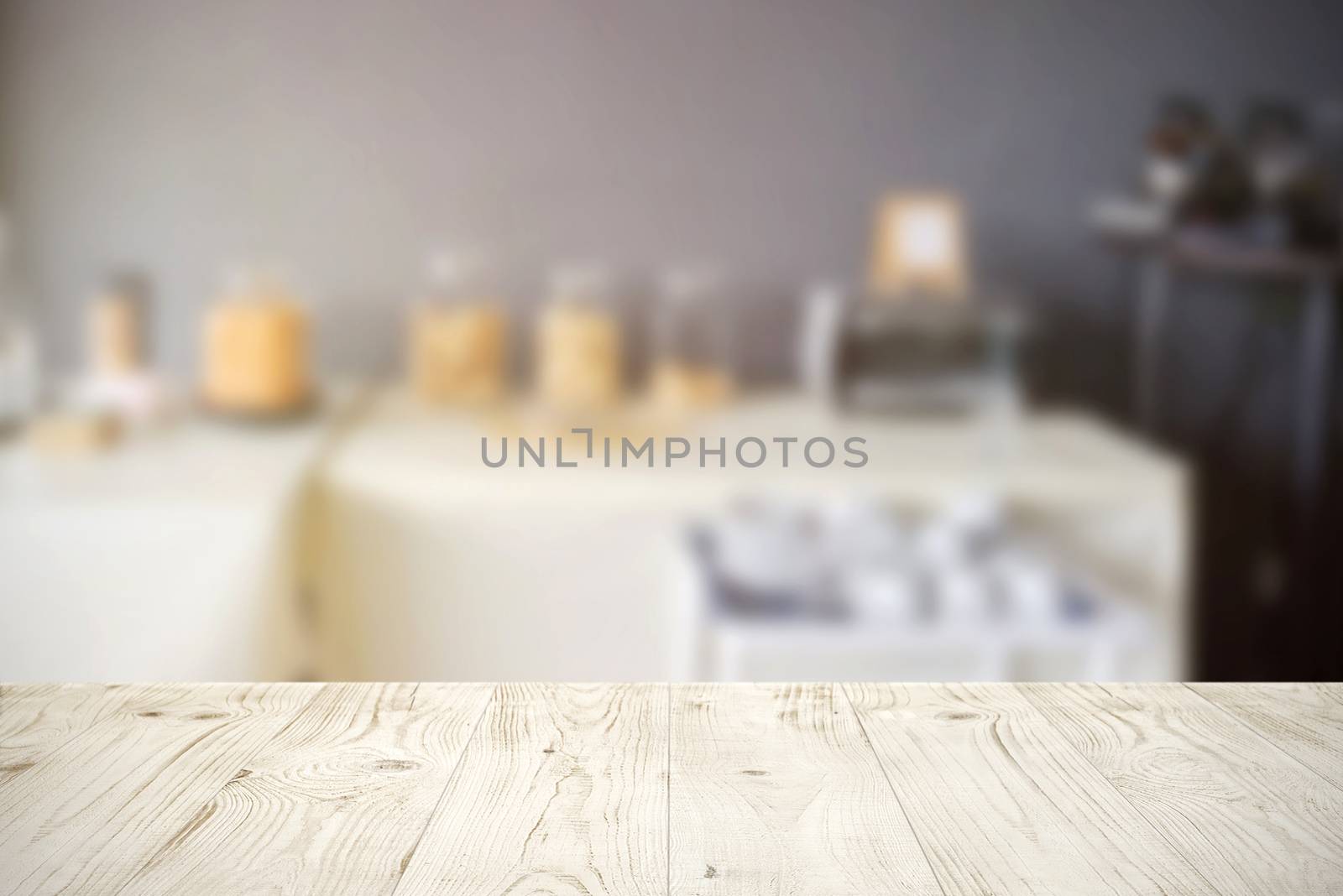 Empty wooden board table top on blur abstract of restaurant or c by nuchylee