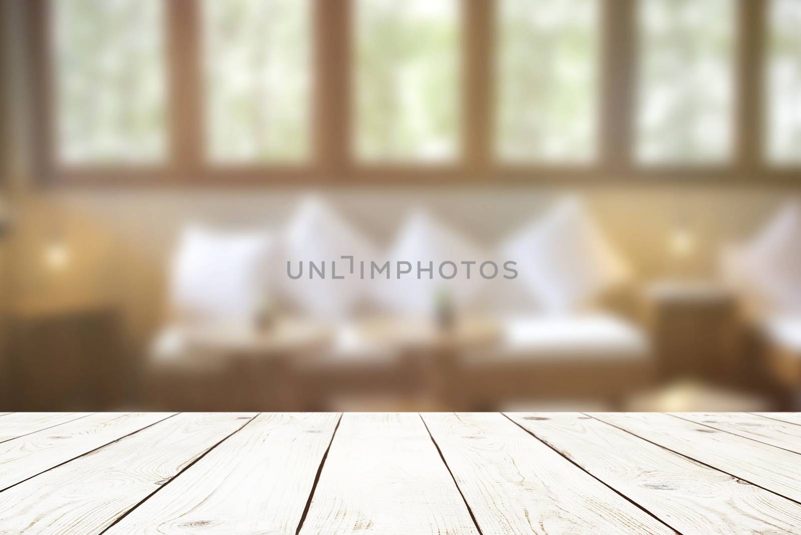Empty wood table top on blur abstract of interior in cafe or liv by nuchylee