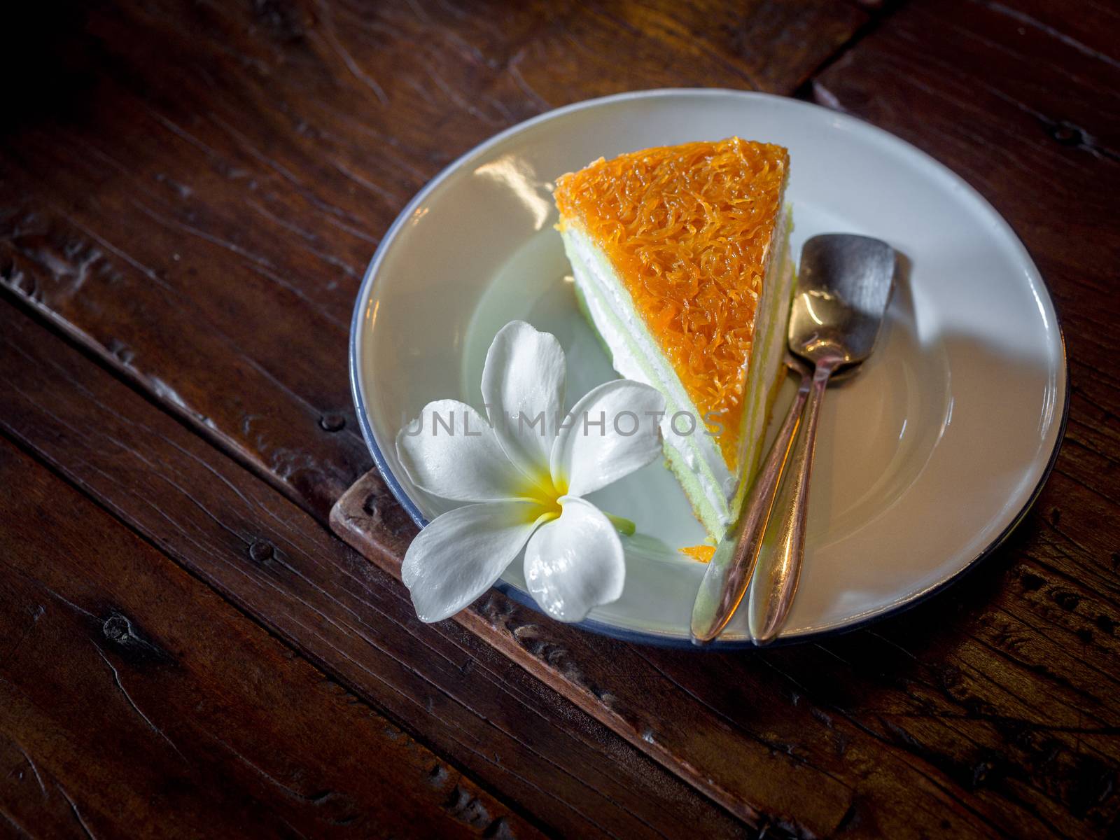 Foi thong cake with spoon and fresh white plumeria flower on zin by tete_escape