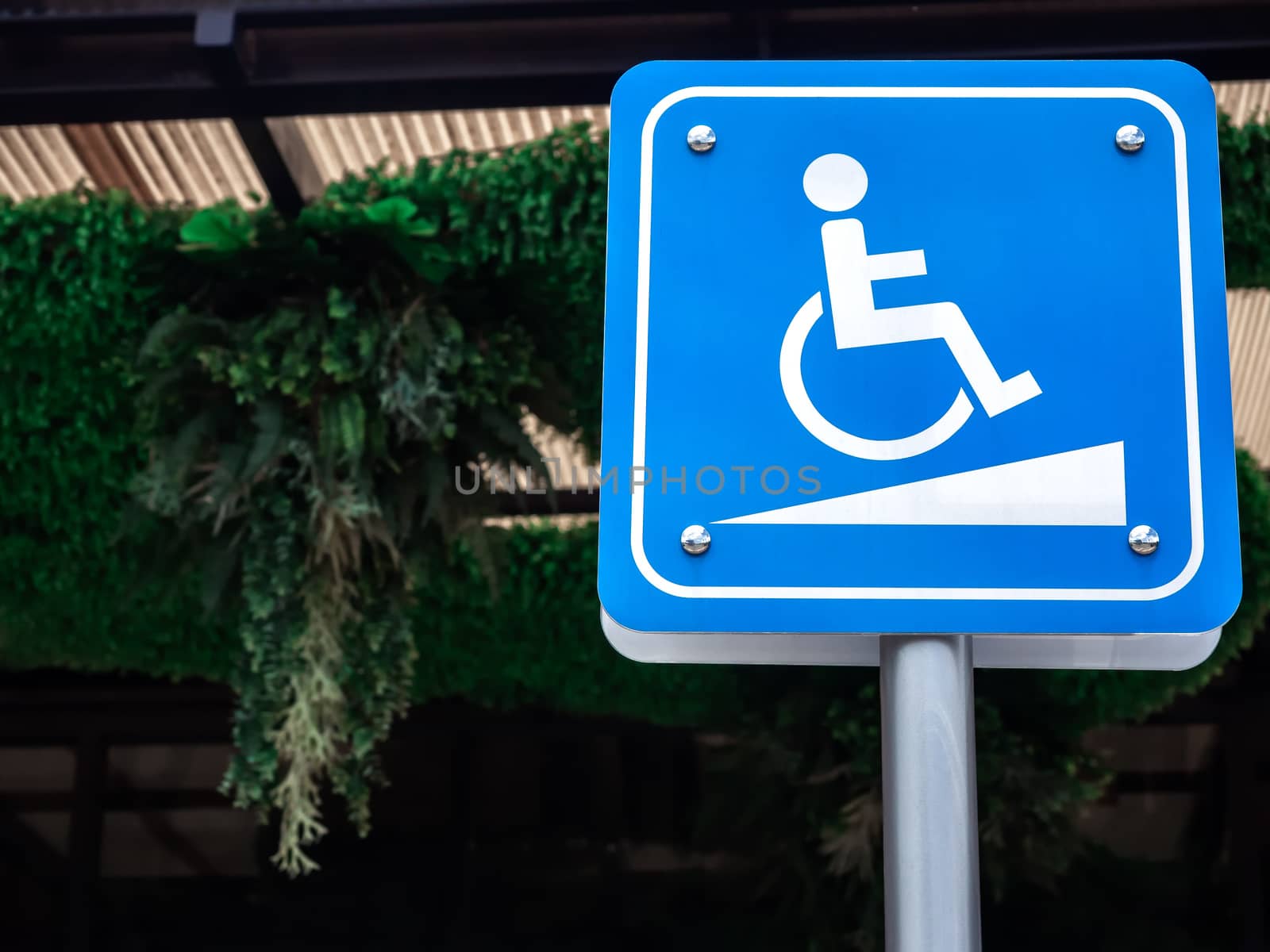 Disabled way sign wth copy space. Wheelchair symbol on blue sign disabled sign for support wheelchair disabled people.