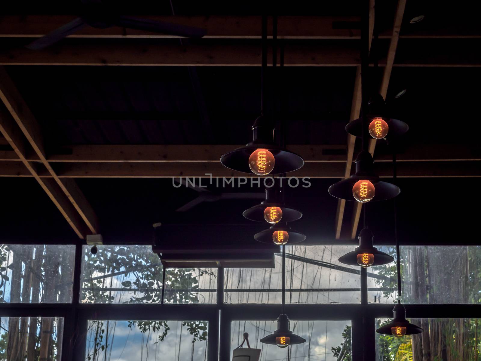 Lighting decoration, vintage ceiling lights hanging from ceiling in cafe, industrial style light bulbs interior design.