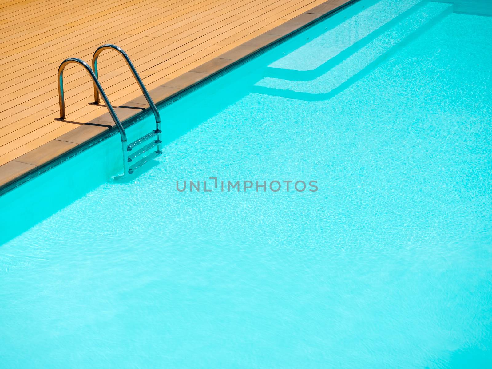 Outdoor swimming pool background minimal style. Grab bars ladder in the blue swimming pool with copy space.