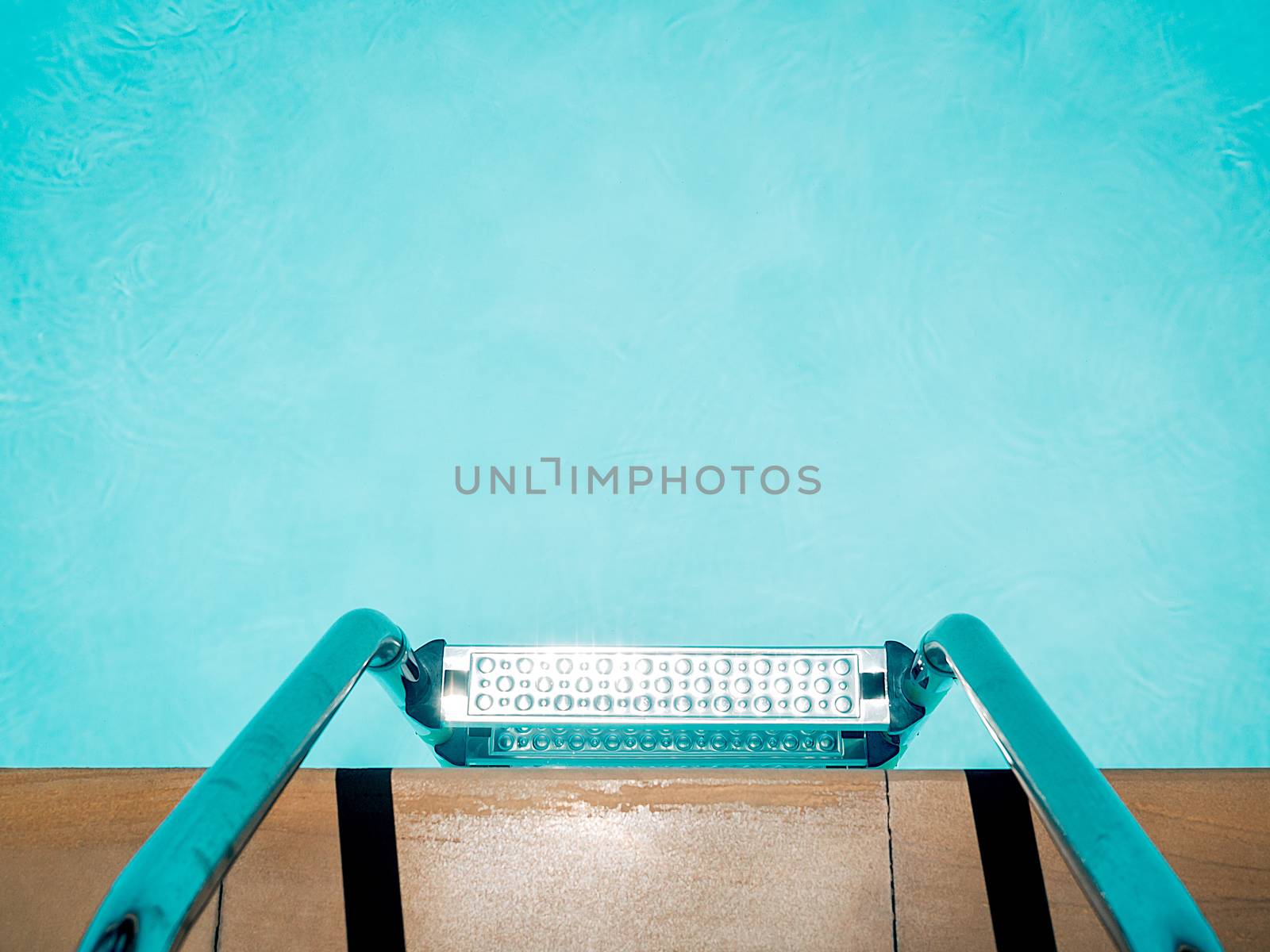 Outdoor swimming pool background minimal style. Top view of grab bars ladder in the blue swimming pool with copy space.