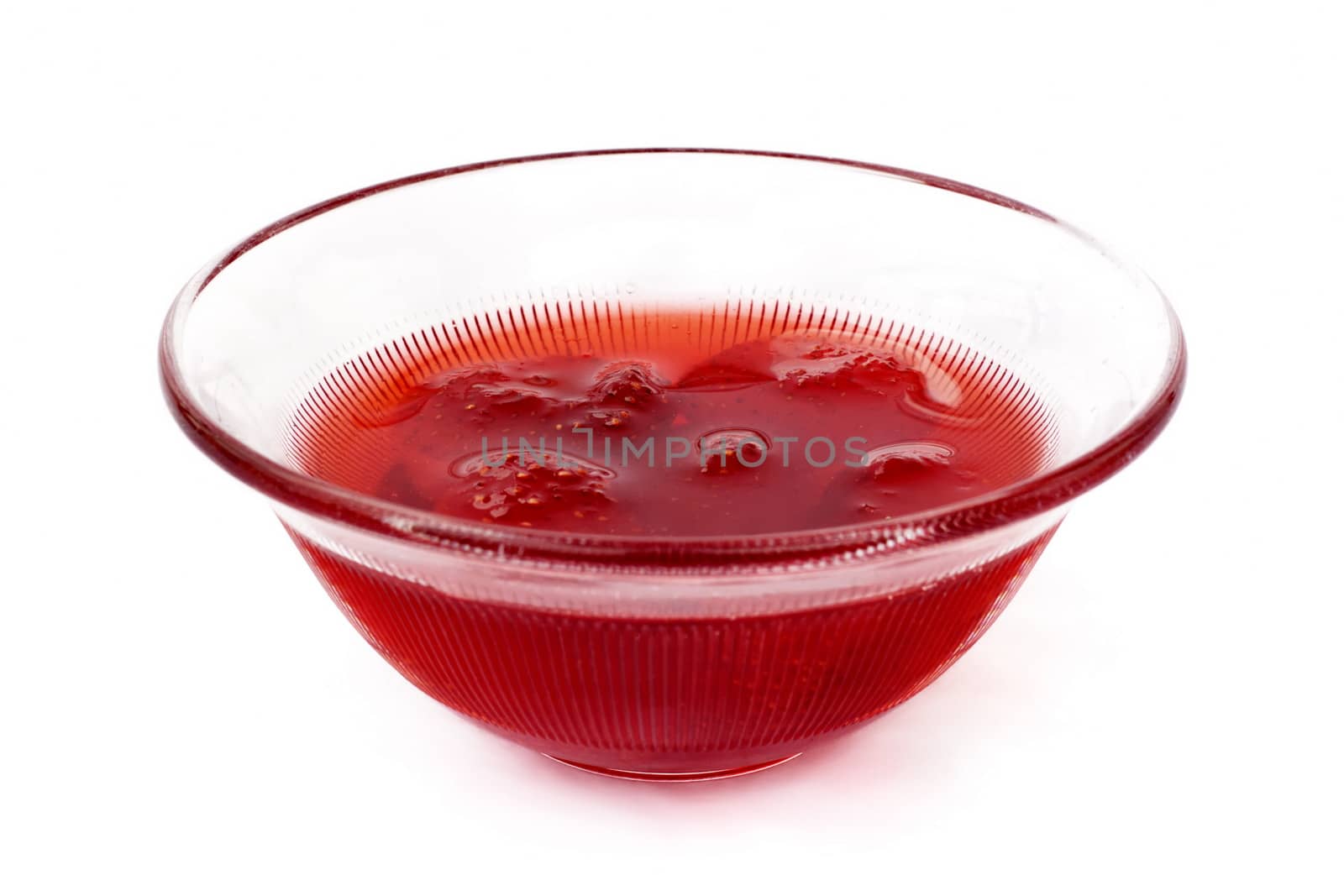 Cup of strawberry jam on white background