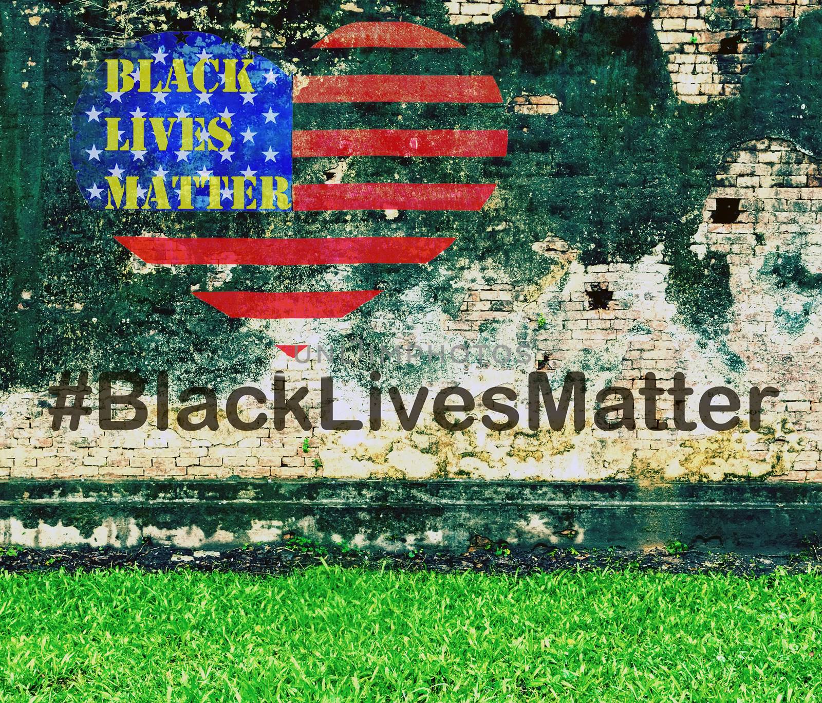 Black Lives Matter slogan hashtag liberation banner protestors heart stencil on American flag USA city street Green grass and old brick wall background urban cracked building