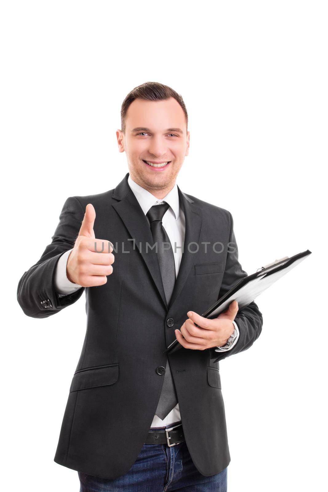 Handsome confident smiling businessman in a suit standing, holding a clipboard and giving thumb up gesture, isolated on white background. Young attractive businessman wearing a suit and tie giving thumb up.
