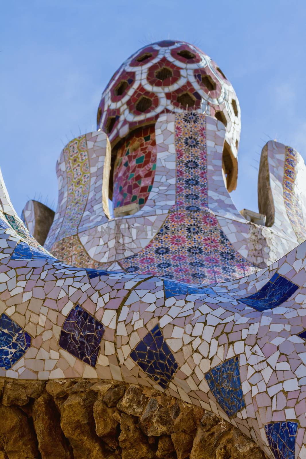 Detail of colorful mosaic work of Park Guell. Barcelona of Spain by Digoarpi