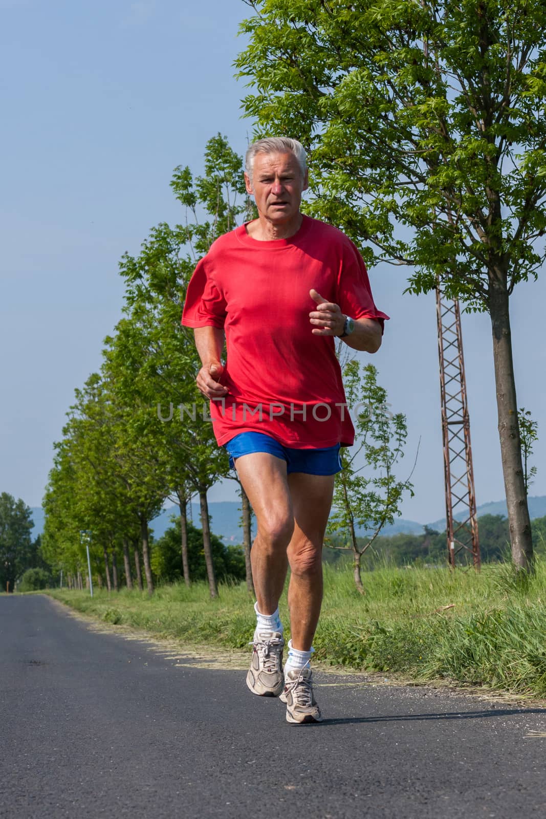 Senior runner while training for a competition by Digoarpi