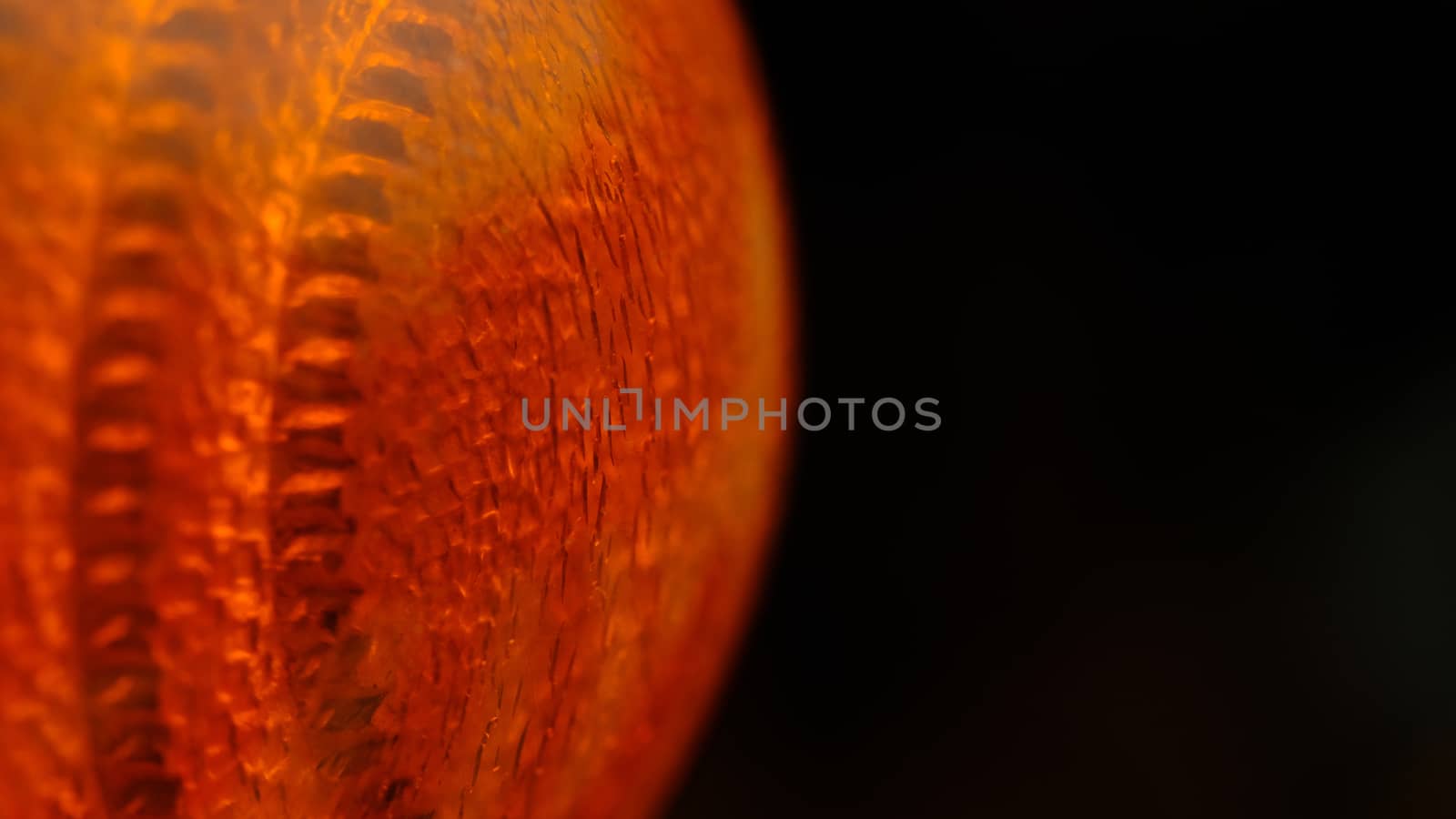 Closeup macro photography of orange glass lamp texture. Illuminated background photo