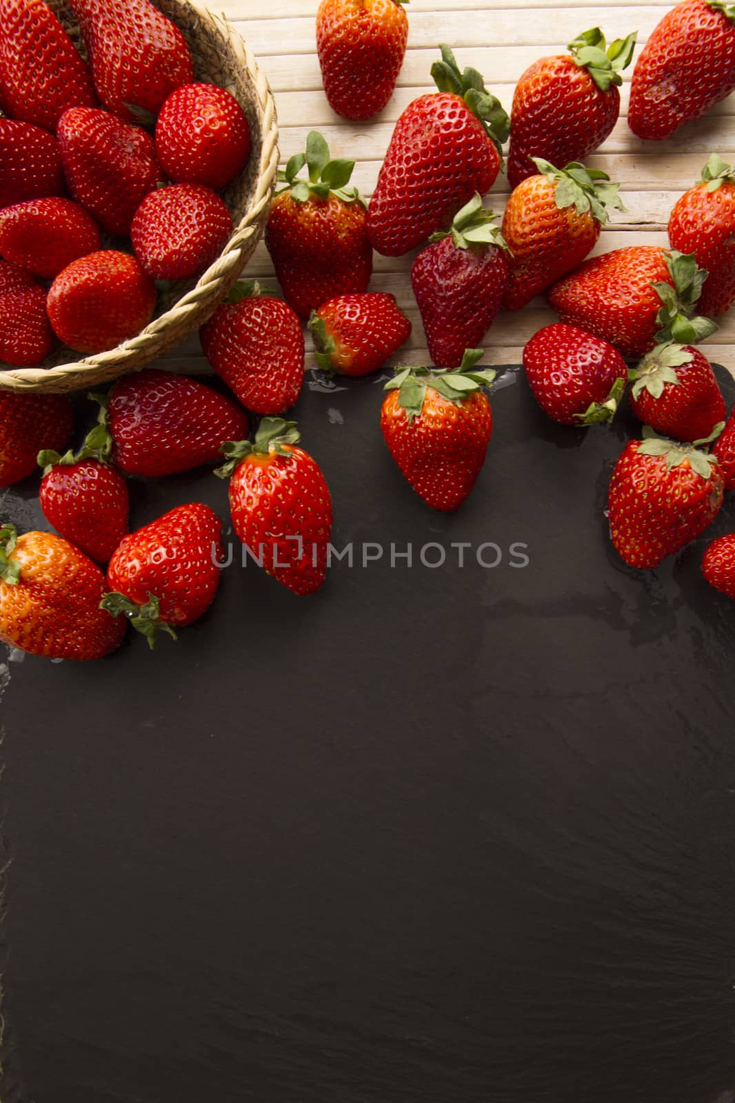 Strawberries copy space with a small basket of strawberries surr by robbyfontanesi