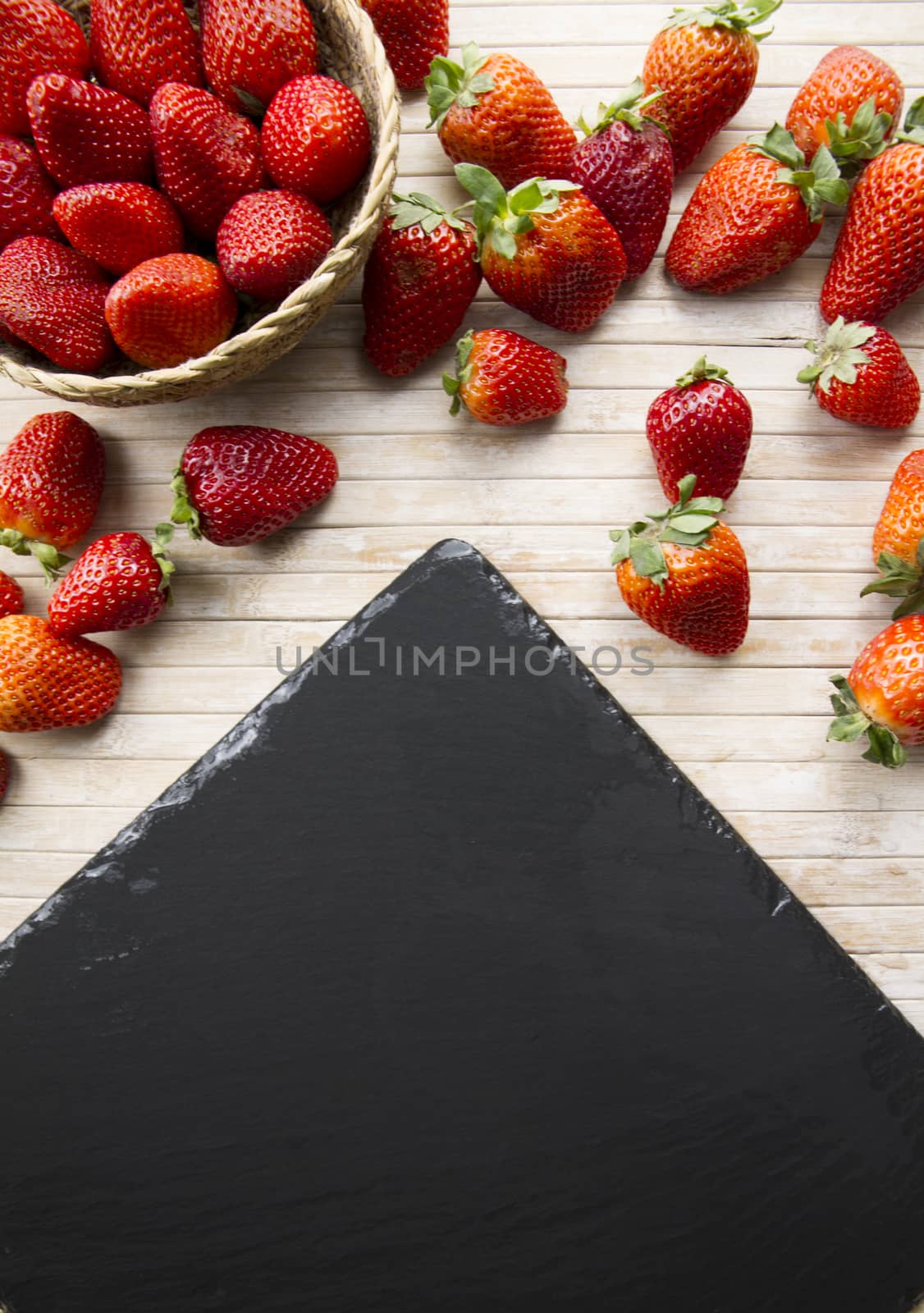 Strawberries copy space with a small basket of strawberries surr by robbyfontanesi