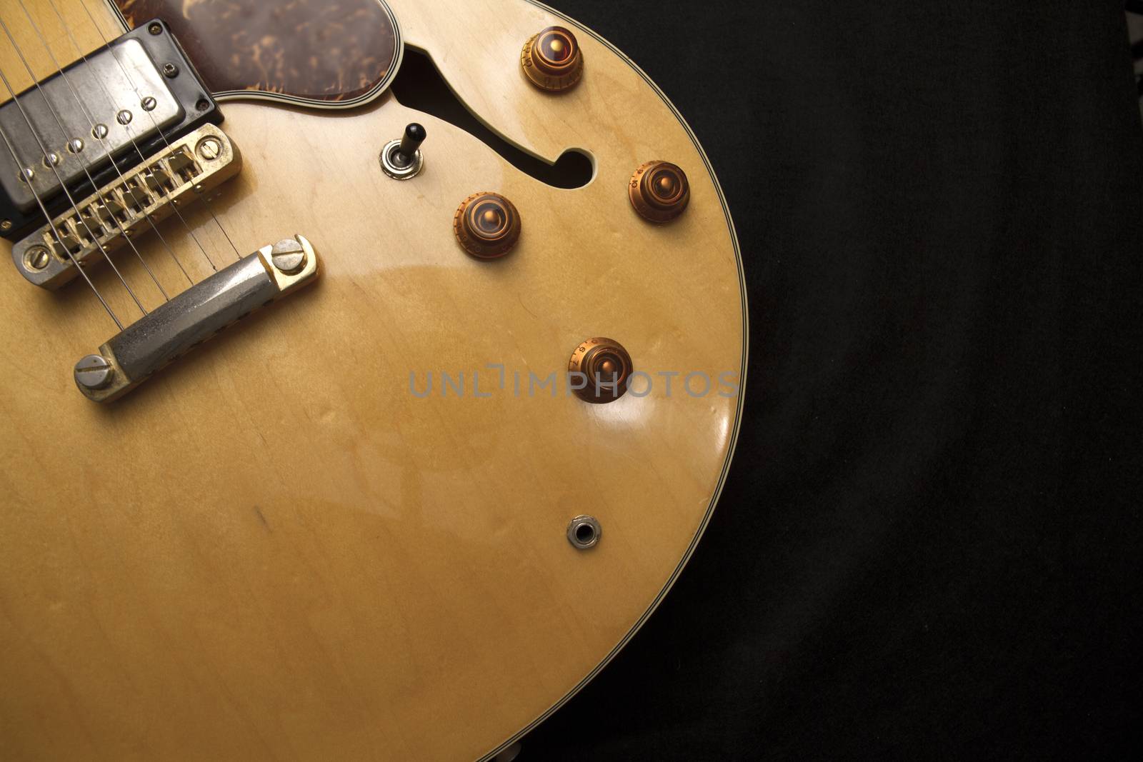 Vintage archtop guitar in natural maple close-up from above on b by robbyfontanesi