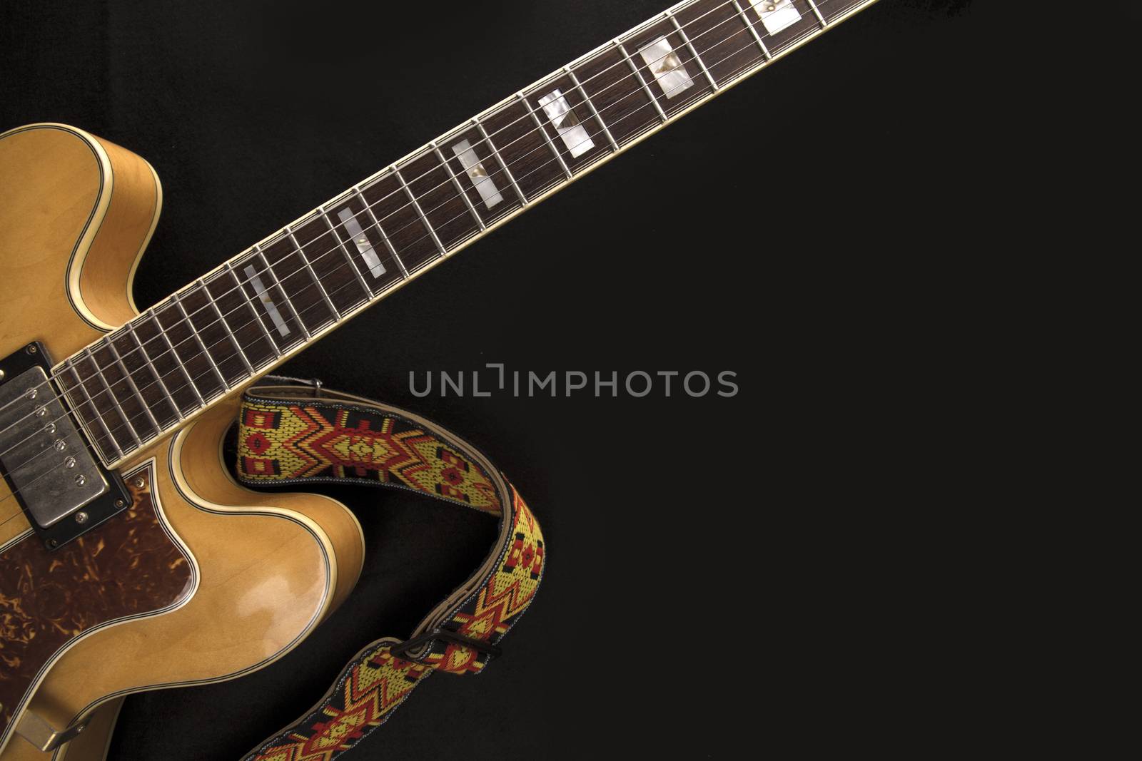 Vintage archtop guitar in natural maple close-up with colored st by robbyfontanesi