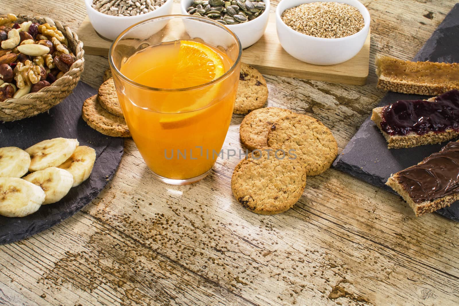 Wooden table set for a sweet vegan breakfast with orange juice,  by robbyfontanesi