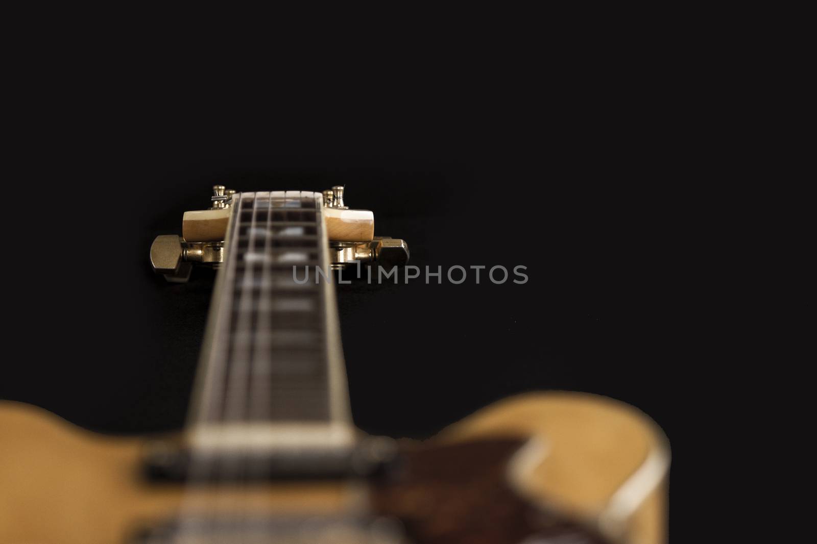 Vintage archtop guitar in natural maple close-up high angle view by robbyfontanesi