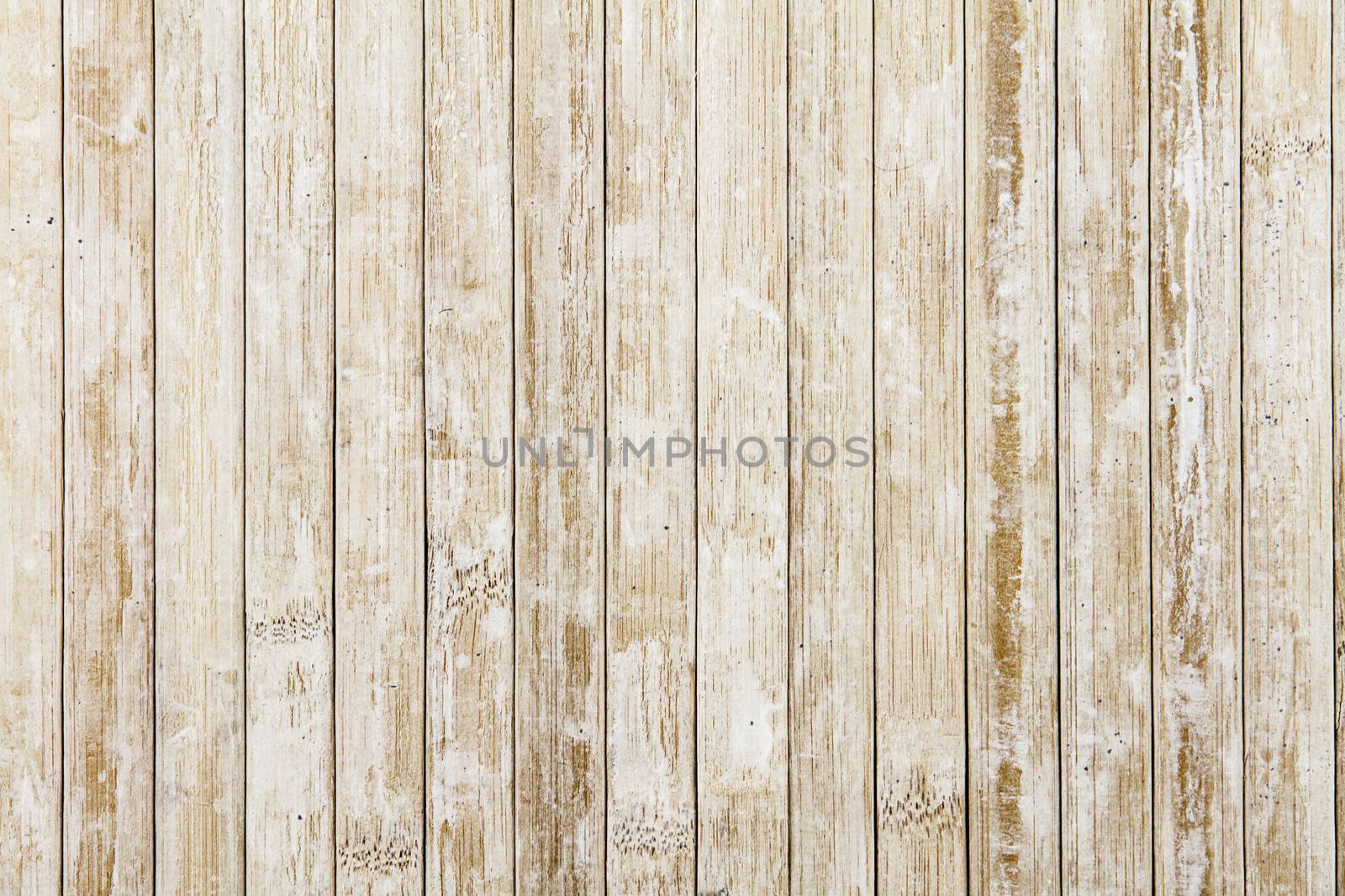 Light wooden background composed of vertical wooden planks ruined by time