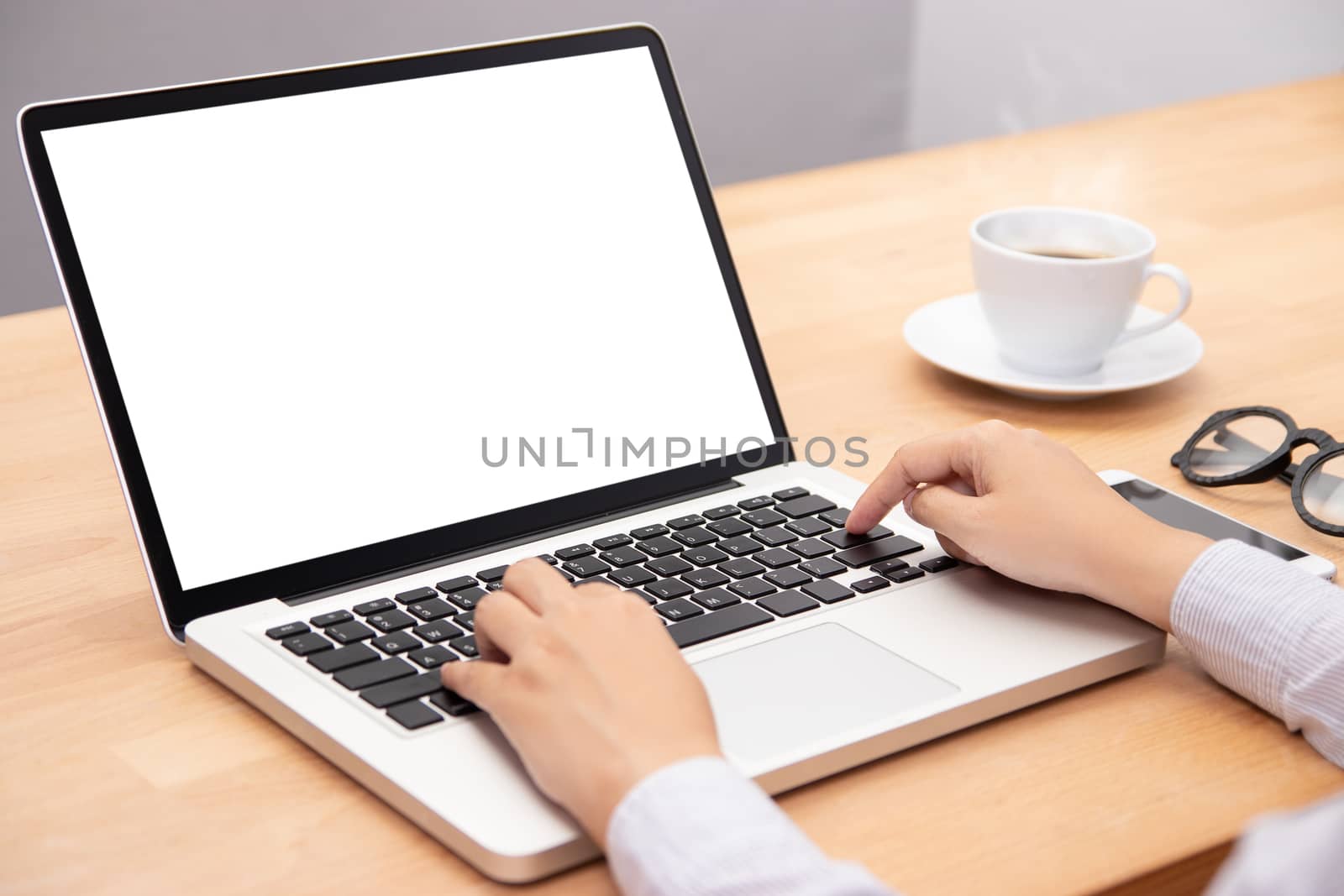 businesswoman working with notebook laptop computer, using finger with keyboard for typing. computer laptop with blank white screen for copy space by asiandelight
