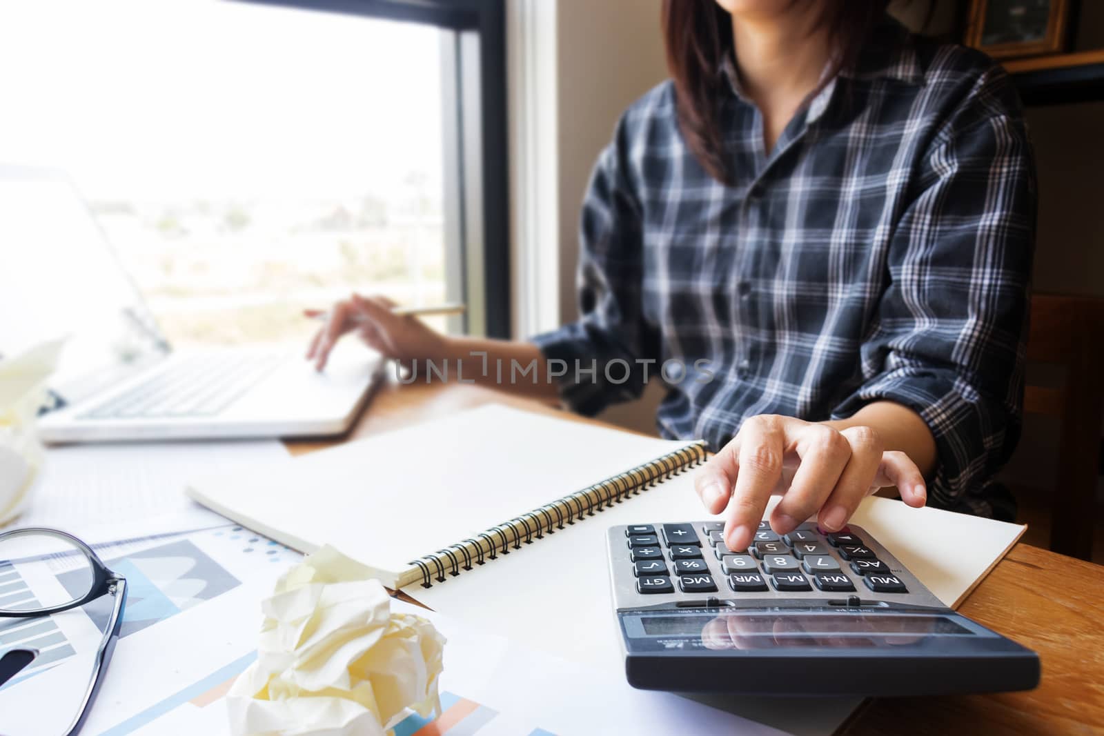 business woman using calculator in office for calculate accounting and financial as accountant job. close up at finger on calculator by asiandelight