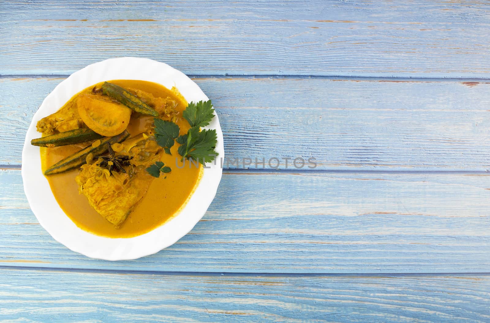 Spicy and tasty fish curry dish, Traditional Malaysian cuisine. Selective focus.