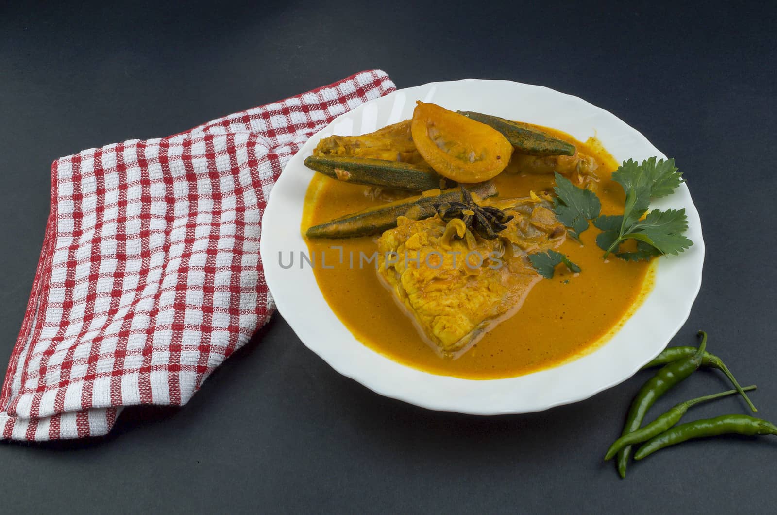 Spicy and tasty fish curry dish, Traditional Malaysian cuisine. Selective focus.