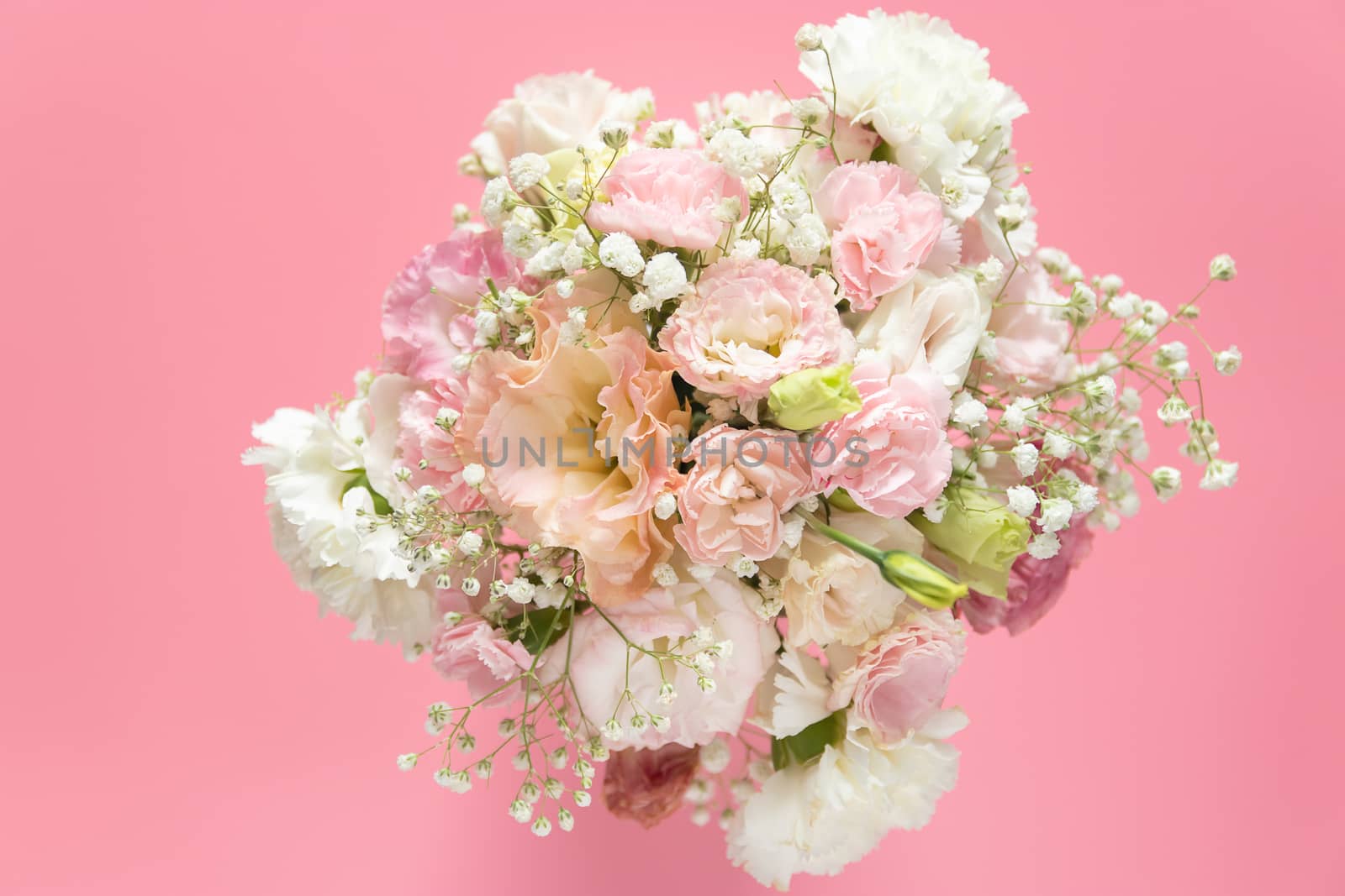 top view of beautiful romantic bouquet fresh flower on pink background with copy space