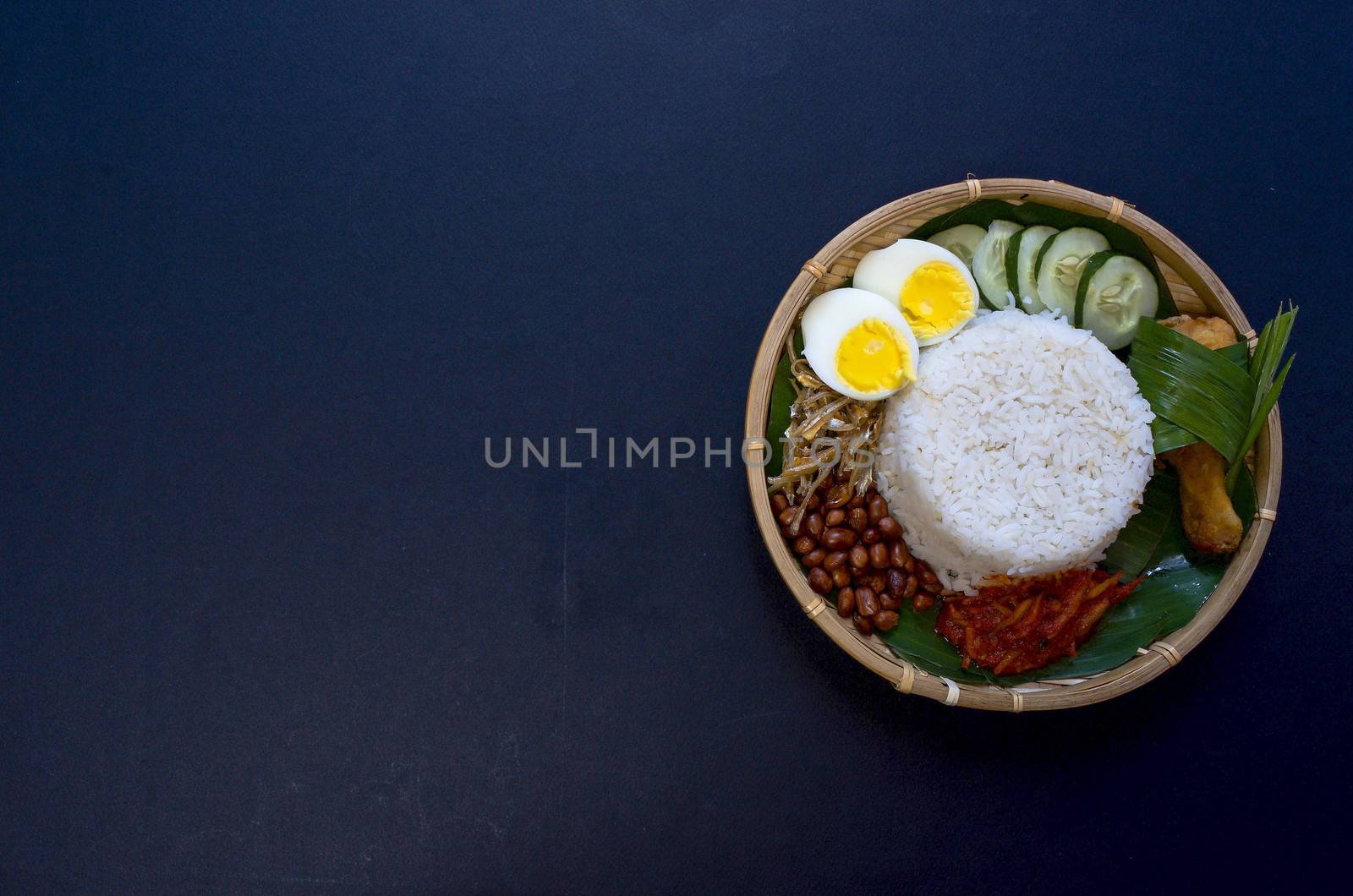 Nasi Lemak is a commonly found food in Malaysia, Brunei and Singapore. It is also an unofficial national food in Malaysia. Selective focus.