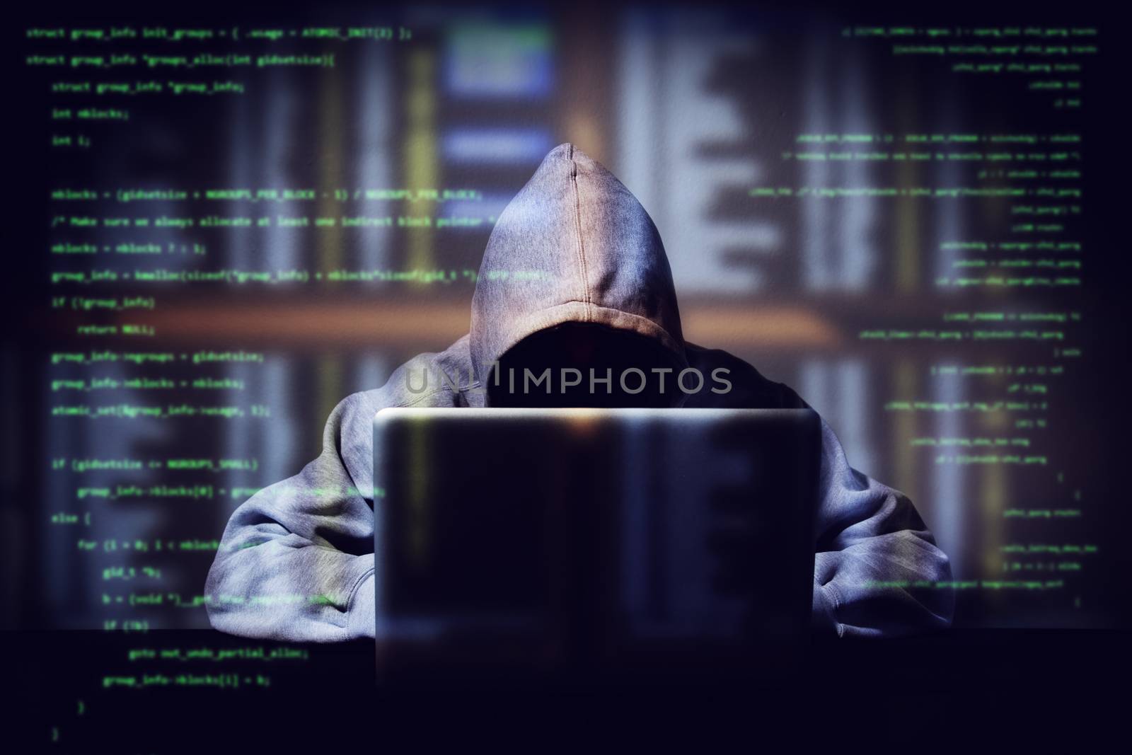 hacker working on a computer code with laptop, double exposure with digital interface around at background. internet crime , hacking and malware concept. anonymous face by asiandelight