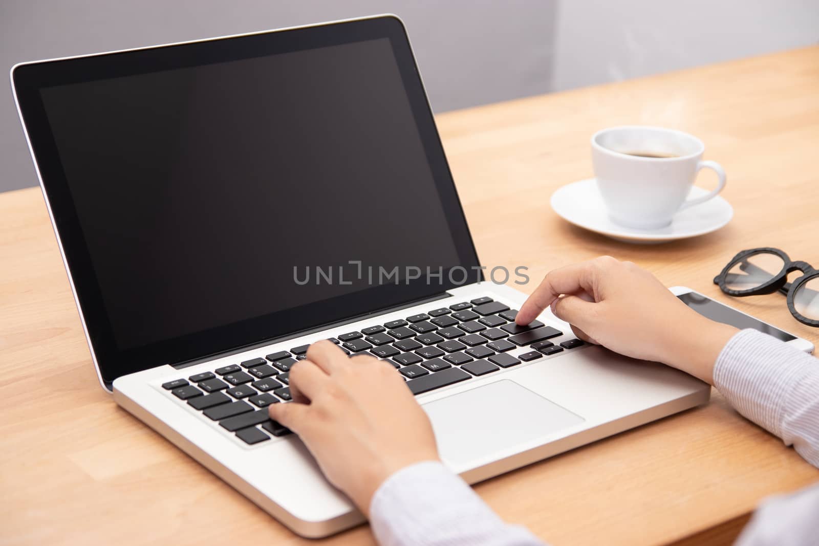 businesswoman working with notebook laptop computer, using finger with keyboard for typing. computer laptop with blank black screen for copy space by asiandelight