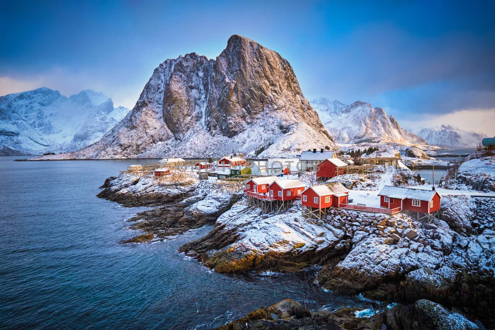 Famous tourist attraction Hamnoy fishing village on Lofoten Islands, Norway with red rorbu houses in winter