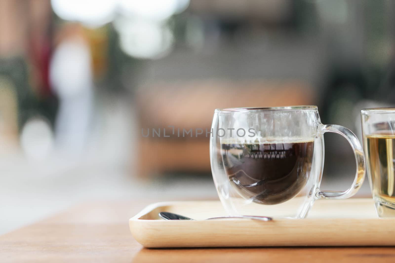 Closeup glass of hot americano coffee on wood table, selective focus, vintage tone