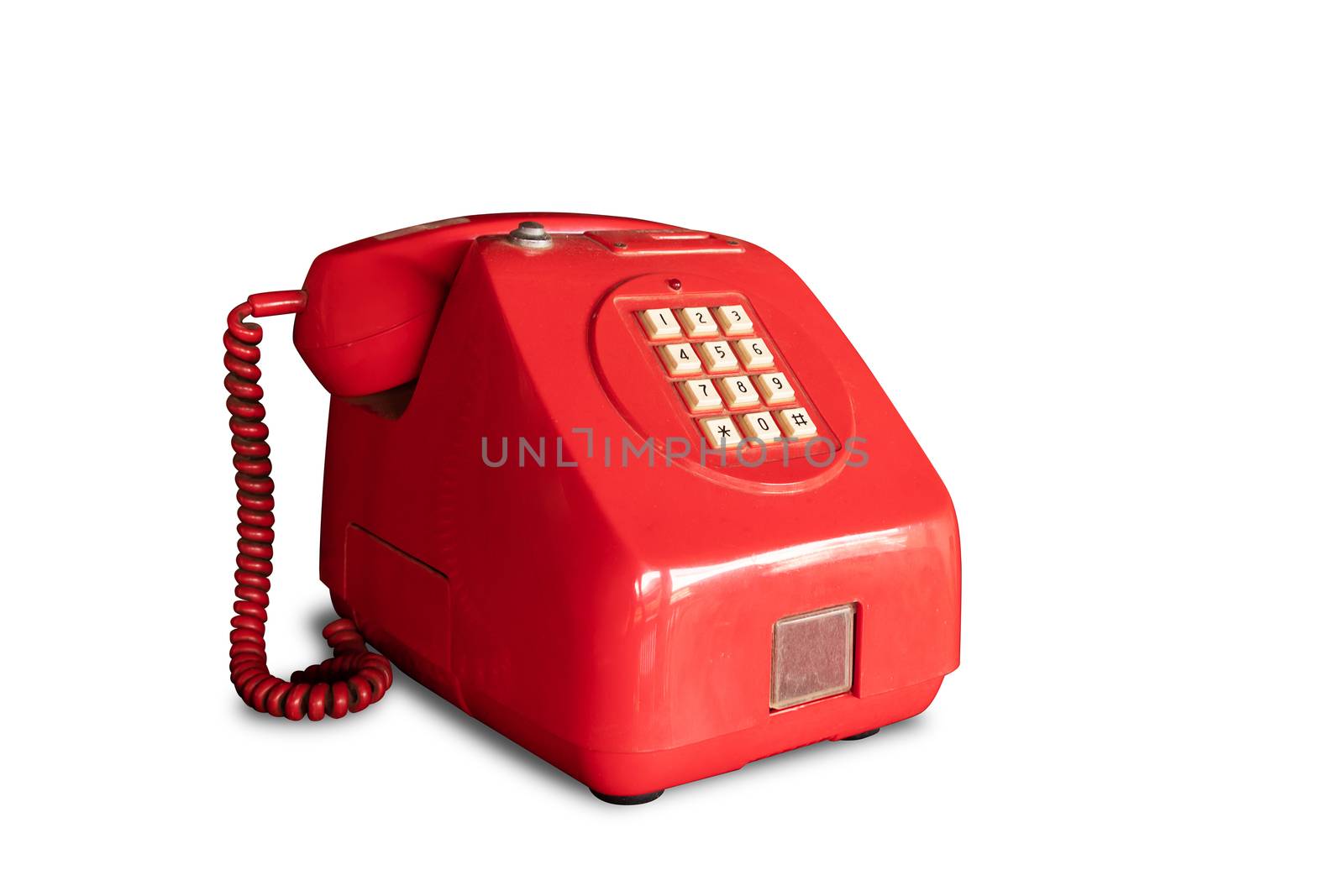 retro red pay phone operated by coins isolated on white background with clipping path by asiandelight