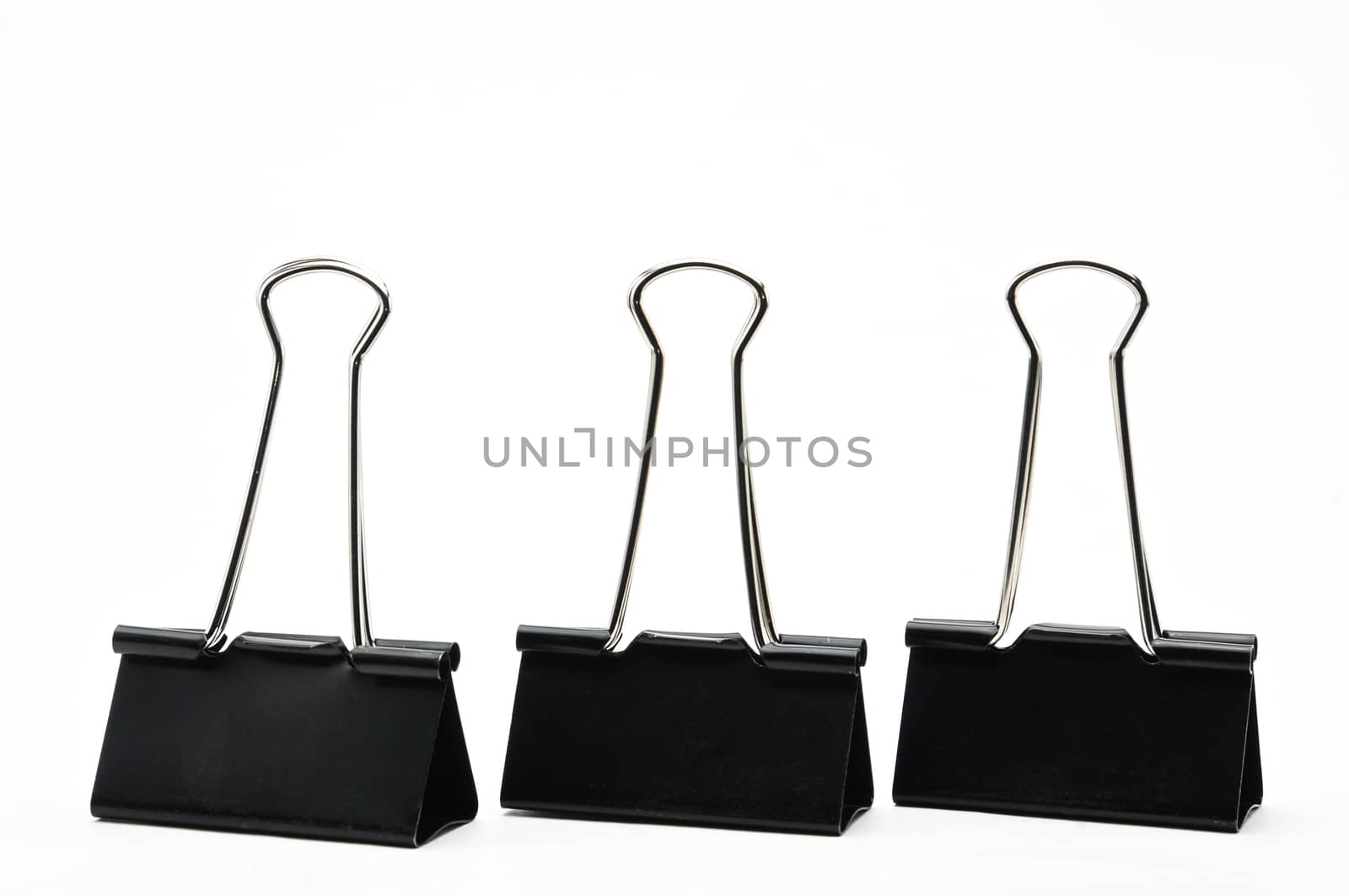 Binder clips paper clamp on an isolated background by moviephoto