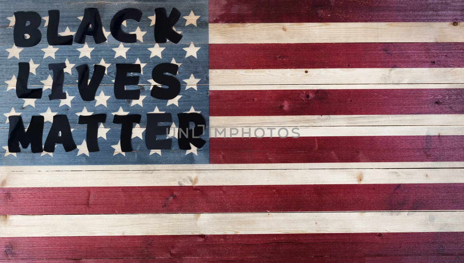 Black lives matter text on United States vintage wooden flag
