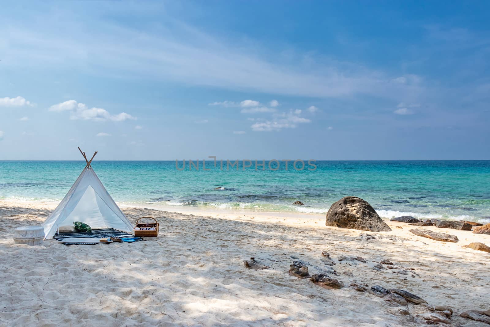 romantic white picnic tent on white sand beach with crystal clear water and blue sky at background by asiandelight
