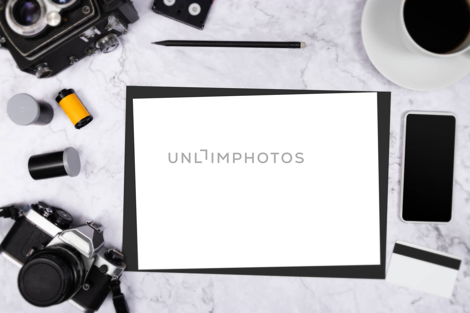 flat lay vintage camera on white marble background with white blank paper and photography tool