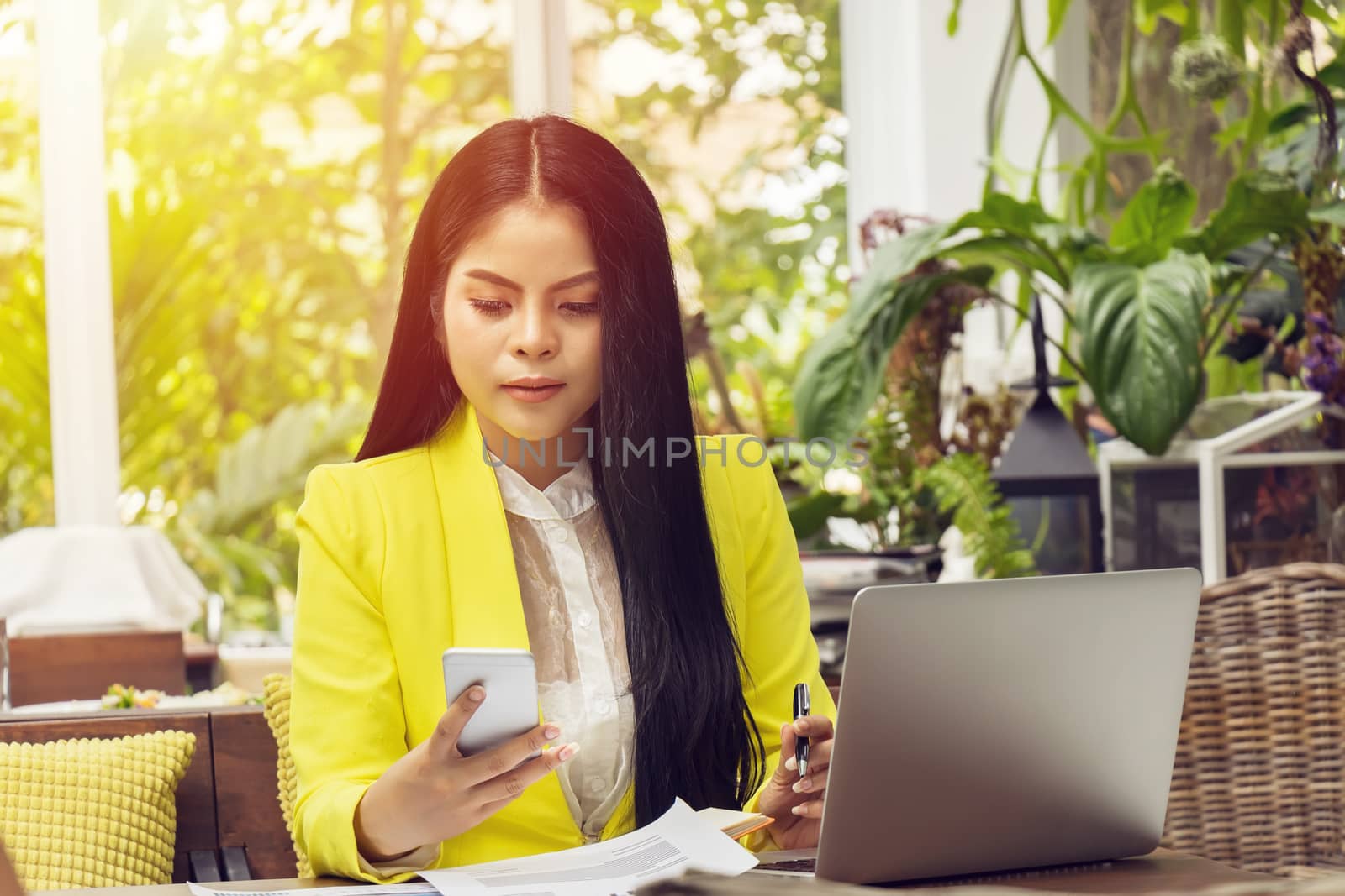 portrait of beautiful and confident Asian business woman in working with notebook laptop and phone manage job work at workplace. happy businesswoman concept by asiandelight