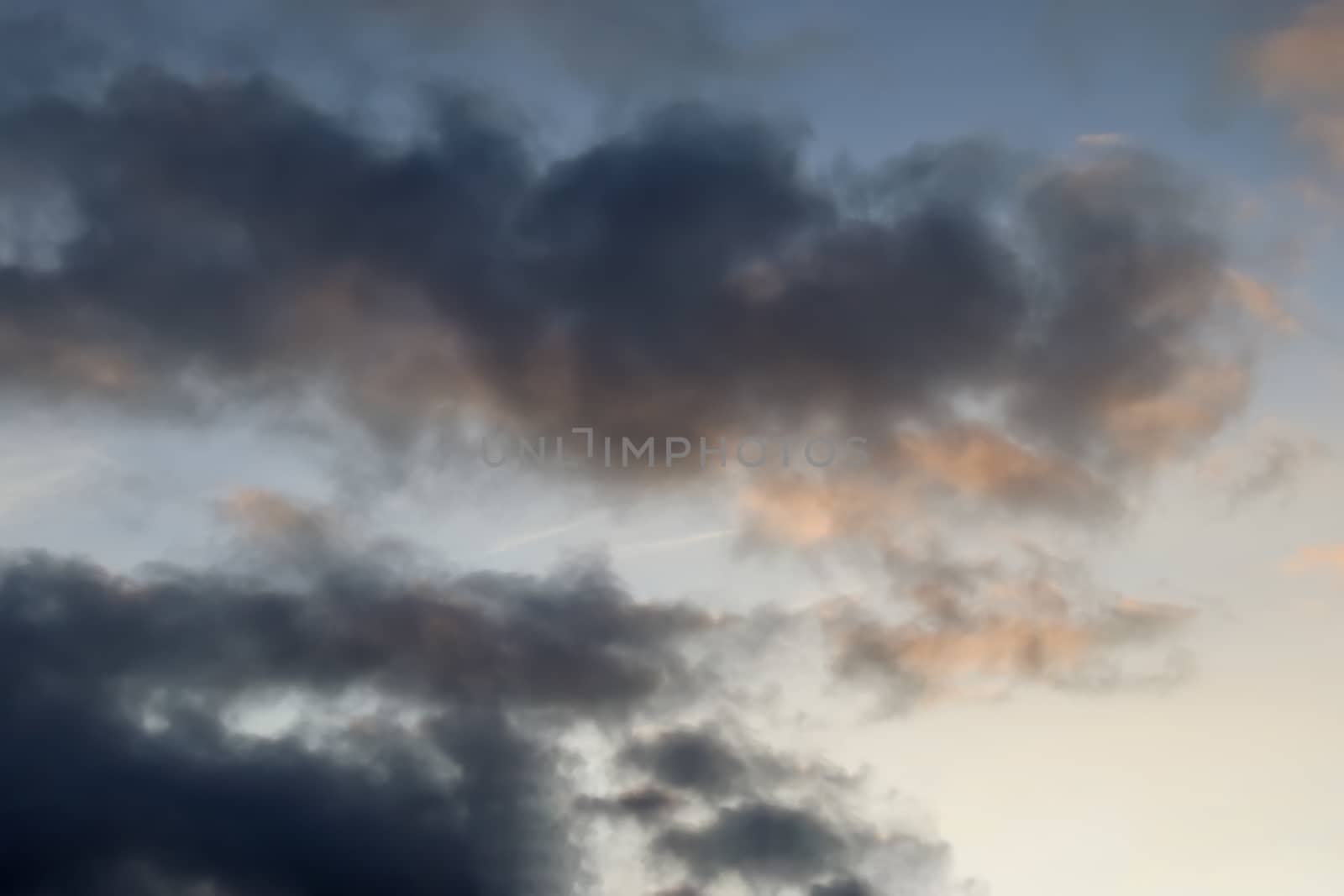 Beautiful panorama of orange and yellow clouds at sunrise and sunset in a blue sky