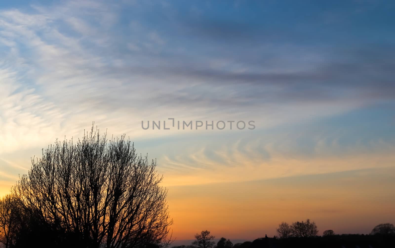 Beautiful panorama of orange and yellow clouds at sunrise and sunset in a blue sky