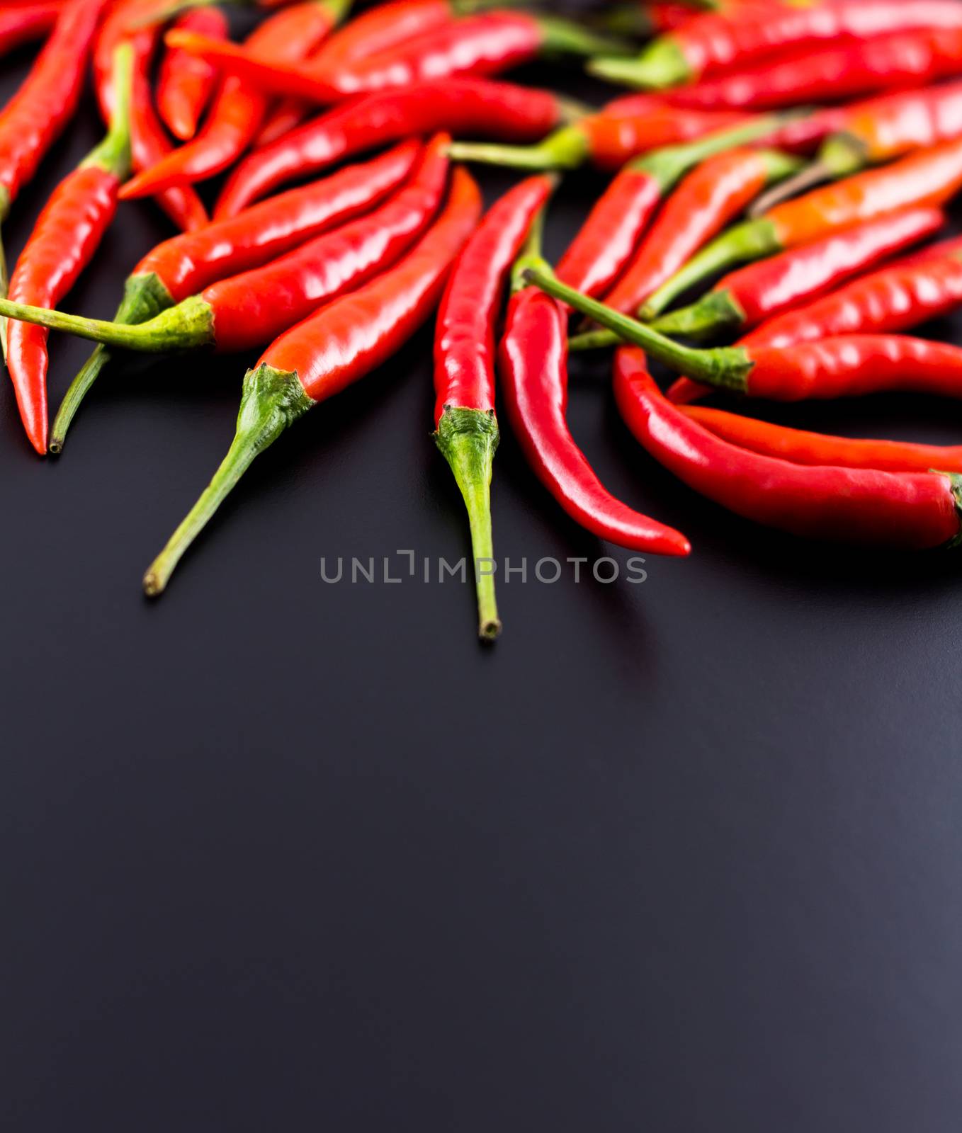 Fresh hot chili on black background, selective focus