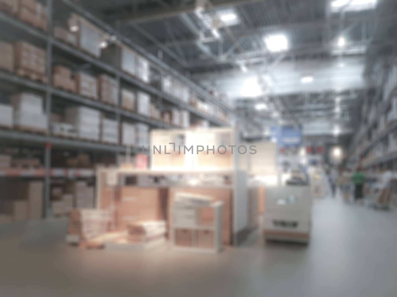 Industrial background - blurred interior view of a large warehouse or logistic corporation with workers