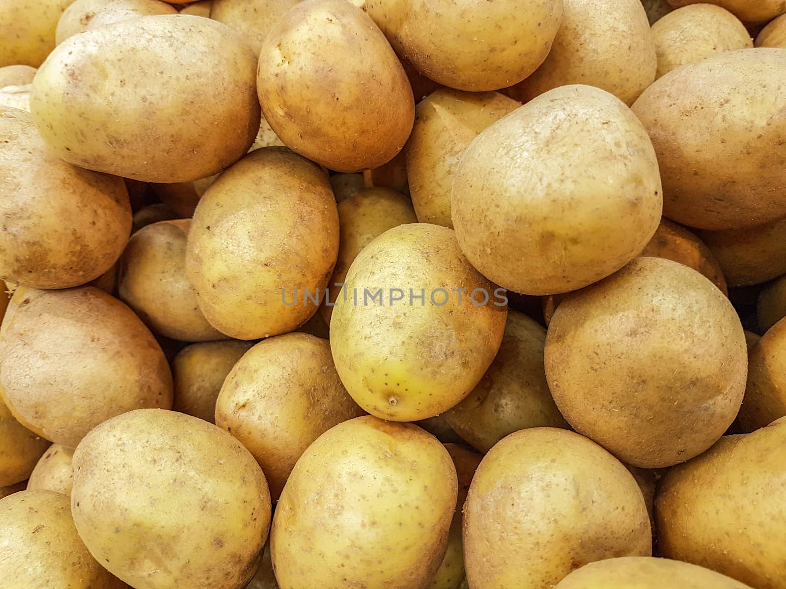 Close-up of a fresh raw potatoes for sale as an agricultural background or texture.