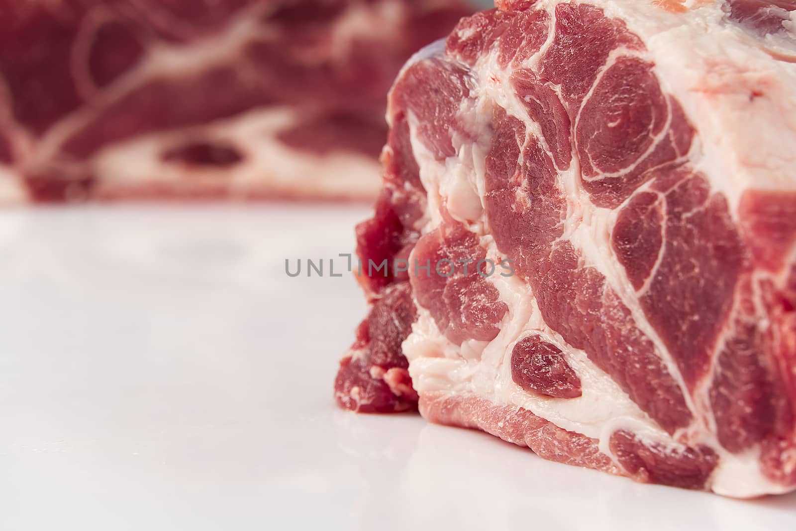 Slice of fresh raw pork meat on white background. by PhotoTime