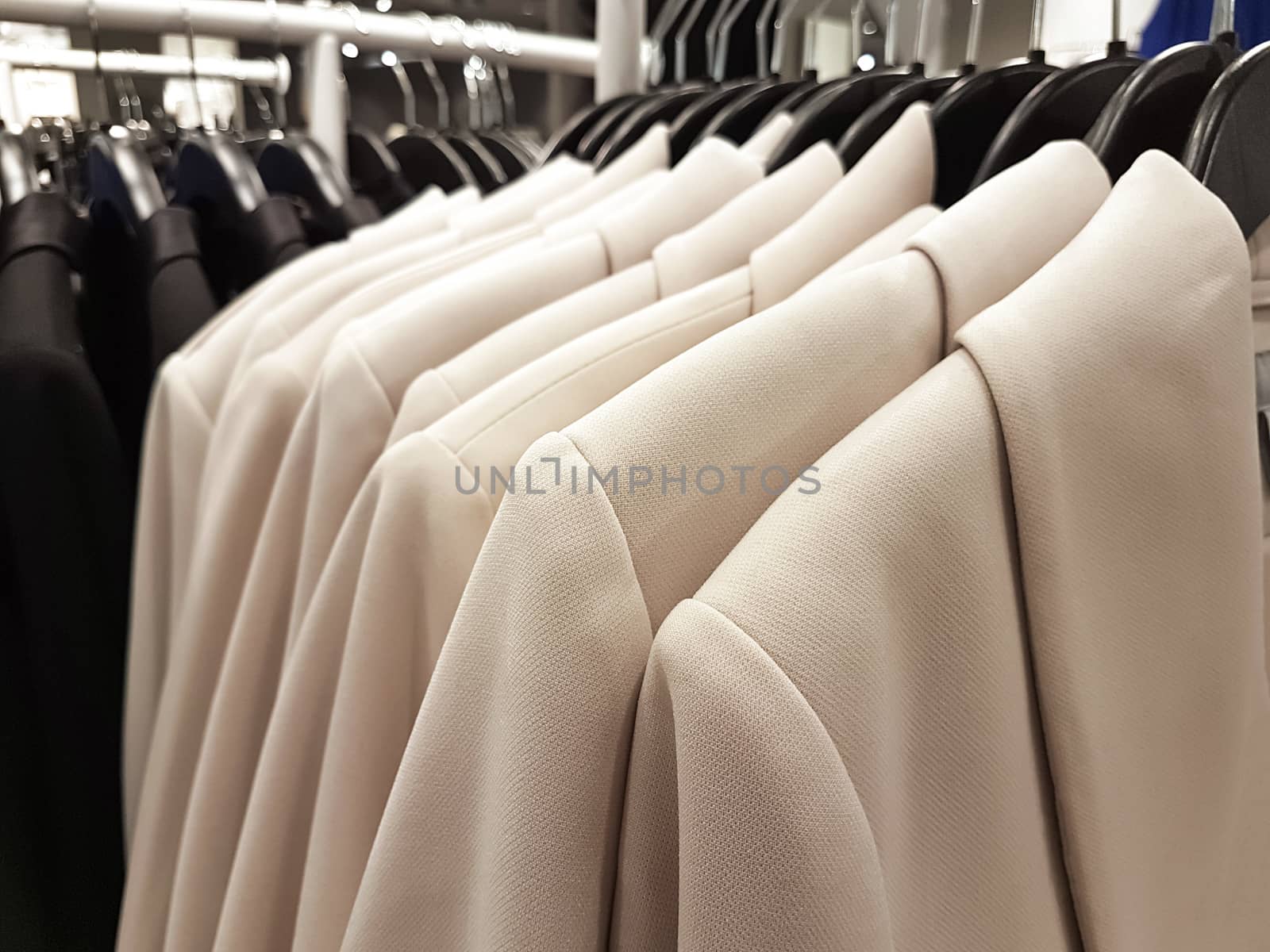 shopping concept image - collection of fashionable clothes hanging in a row in the store ( selective focus)